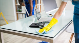 Young Male And Female Cleaners Cleaning Office