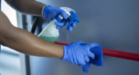 cleaning staff disinfecting the emergency door bar