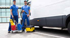 Guy With Vacuum Cleaner And Worker Near Truck
