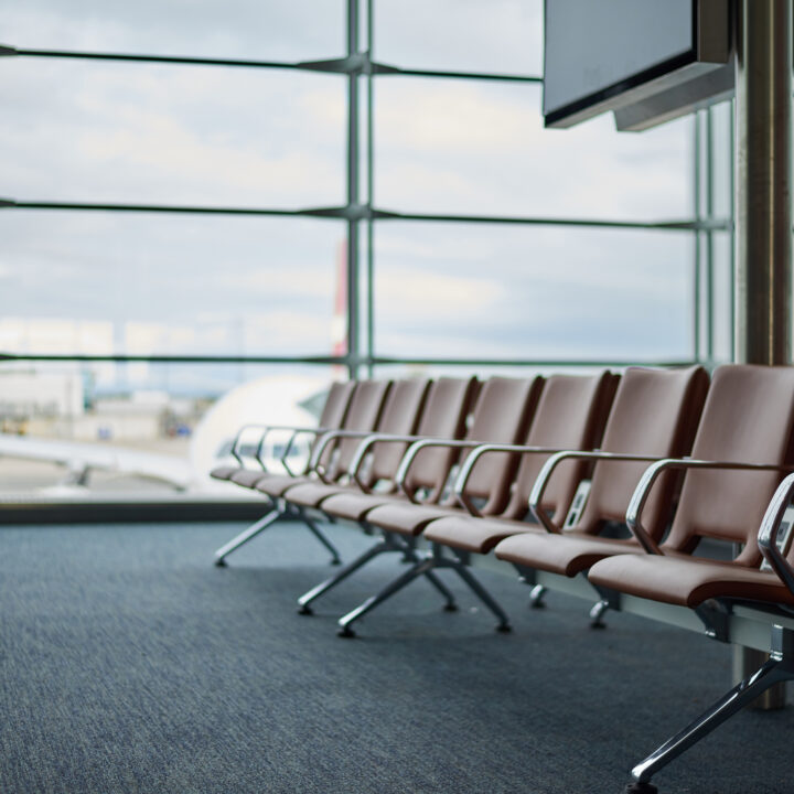 Empty airport with blurred plane and cloudy tragik sky on a background